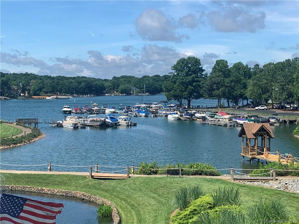an aerial view of a house with a yard and lake view
