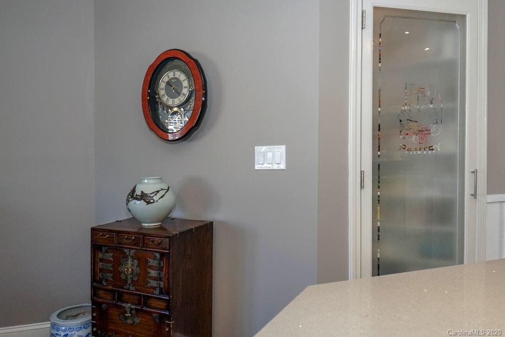 1114 Torrence Circle, Unit 1114 Davidson, NC 28036 - Photo 11 of 29 a view of a hallway that has painting on the wall