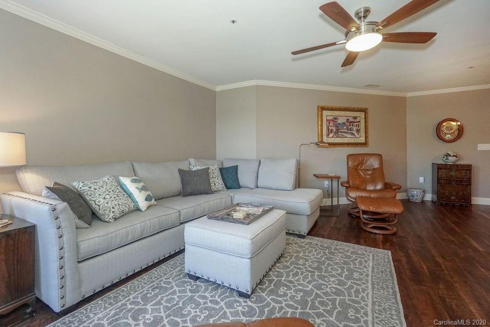 1114 Torrence Circle, Unit 1114 Davidson, NC 28036 - Photo 12 of 29 a living room with furniture and a rug