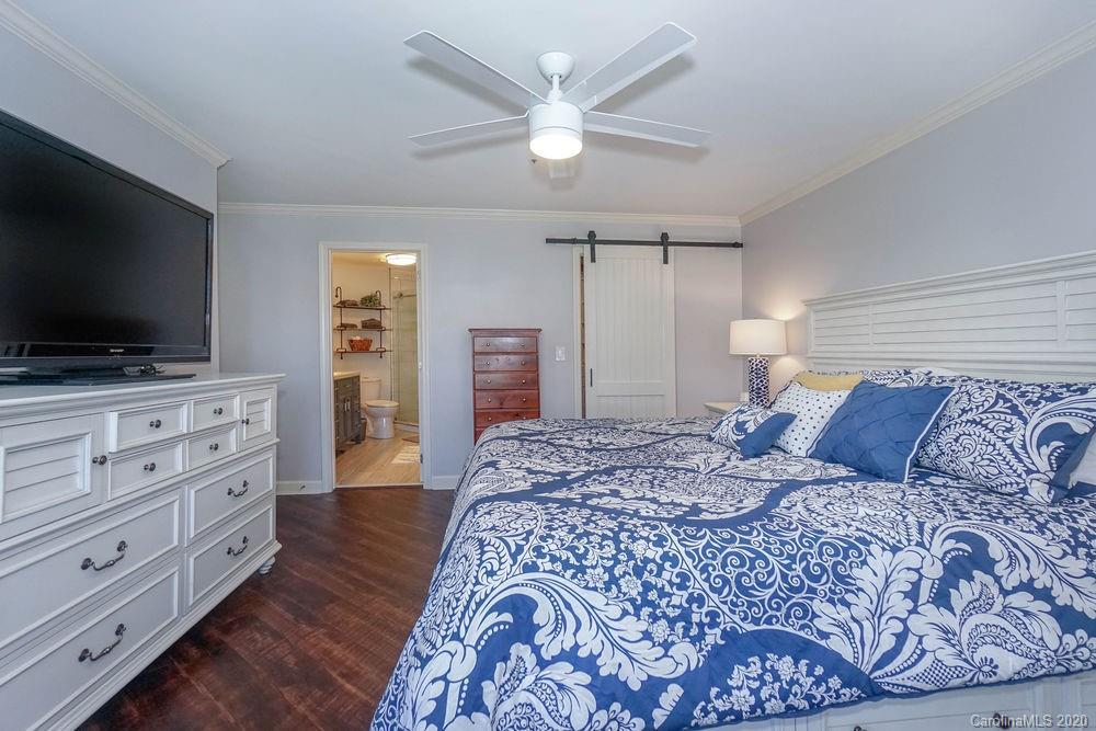 1114 Torrence Circle, Unit 1114 Davidson, NC 28036 - Photo 15 of 29 a living room with furniture and a flat screen tv