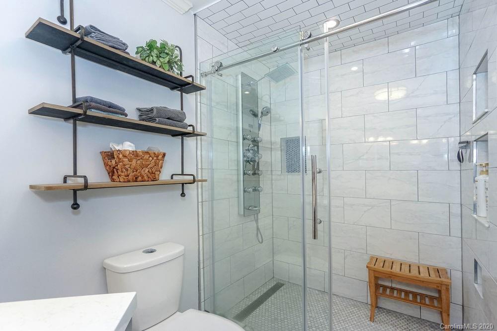 1114 Torrence Circle, Unit 1114 Davidson, NC 28036 - Photo 18 of 29 a bathroom with a shower a toilet and a sink