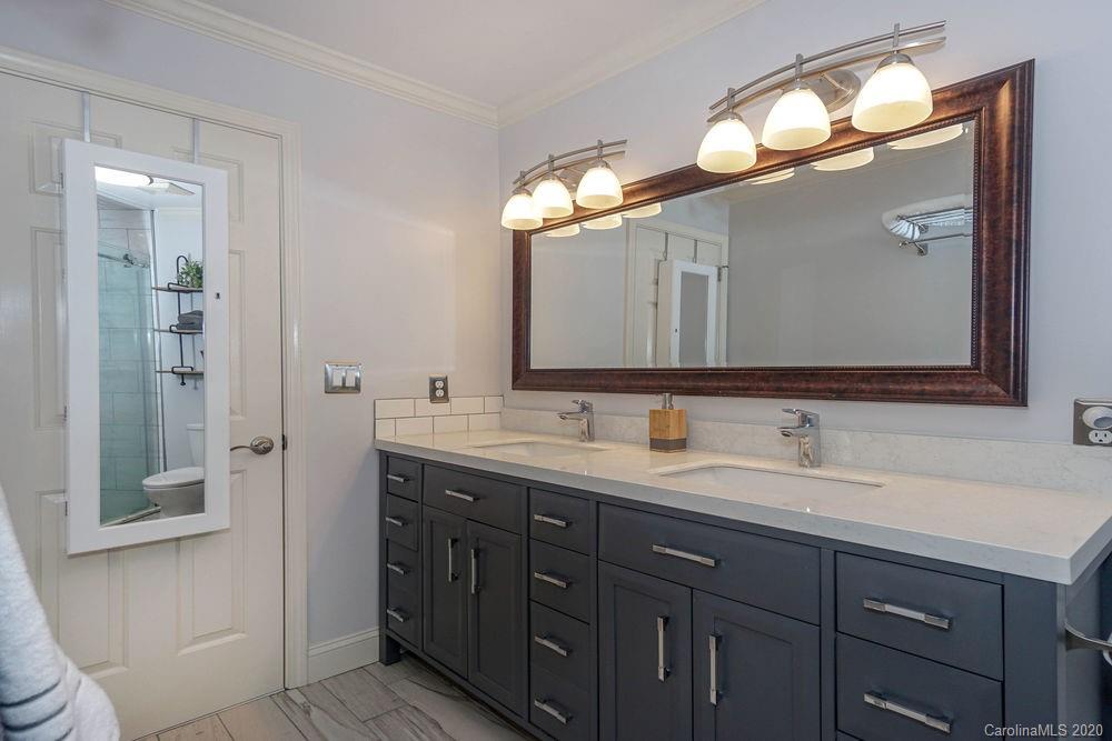 1114 Torrence Circle, Unit 1114 Davidson, NC 28036 - Photo 19 of 29 a bathroom with a double vanity sink and a mirror