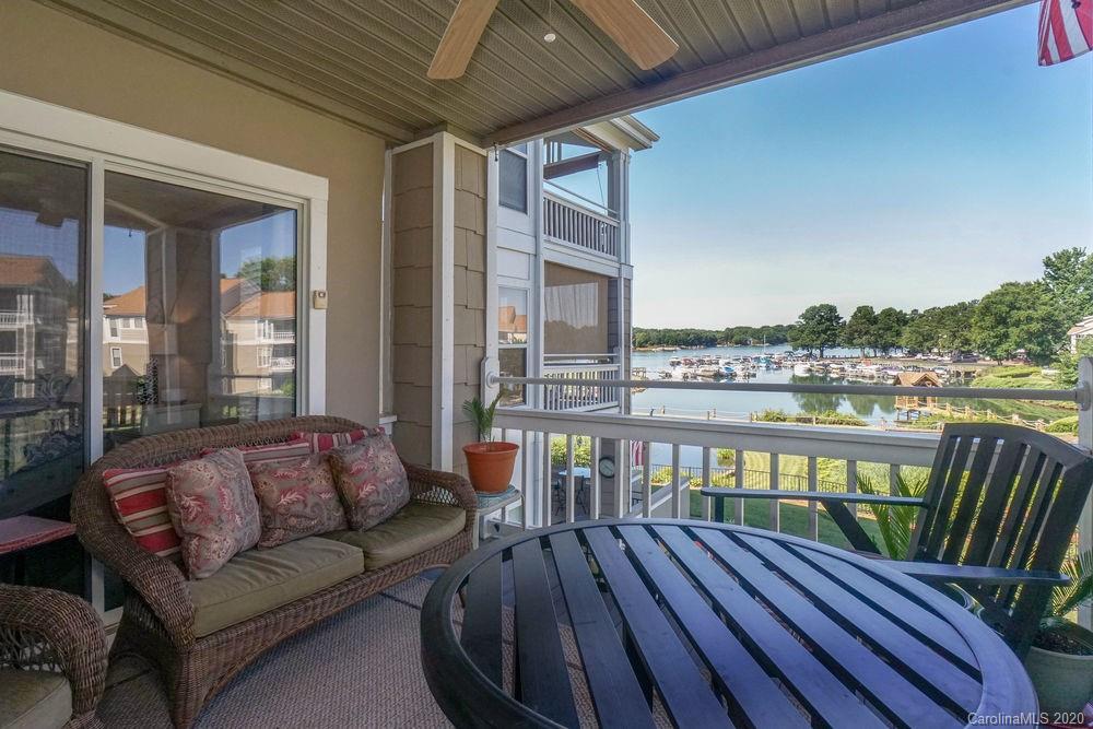 1114 Torrence Circle, Unit 1114 Davidson, NC 28036 - Photo 23 of 29 a balcony with furniture and wooden floor