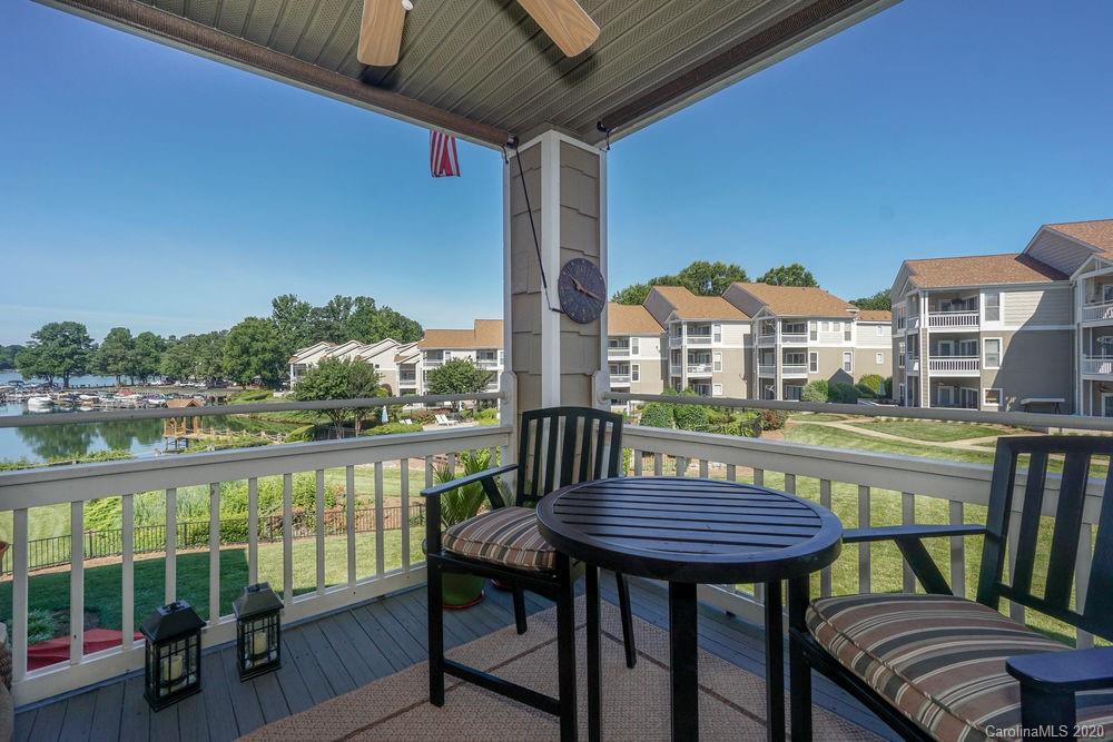 1114 Torrence Circle, Unit 1114 Davidson, NC 28036 - Photo 24 of 29 a view of a balcony with two chairs and a table