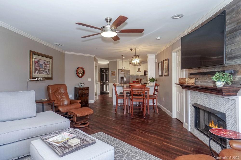 1114 Torrence Circle, Unit 1114 Davidson, NC 28036 - Photo 4 of 29 a living room with furniture and a fireplace