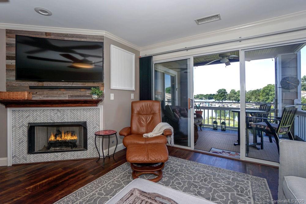 1114 Torrence Circle, Unit 1114 Davidson, NC 28036 - Photo 7 of 29 a living room with furniture and a fireplace