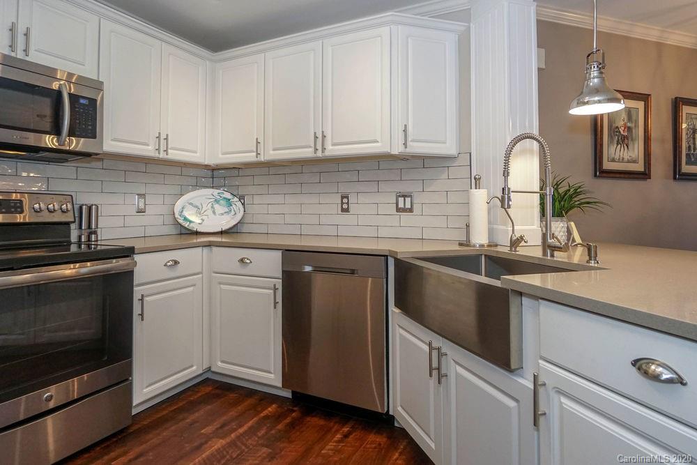 1114 Torrence Circle, Unit 1114 Davidson, NC 28036 - Photo 10 of 29 a kitchen with stainless steel appliances granite countertop a sink stove and microwave