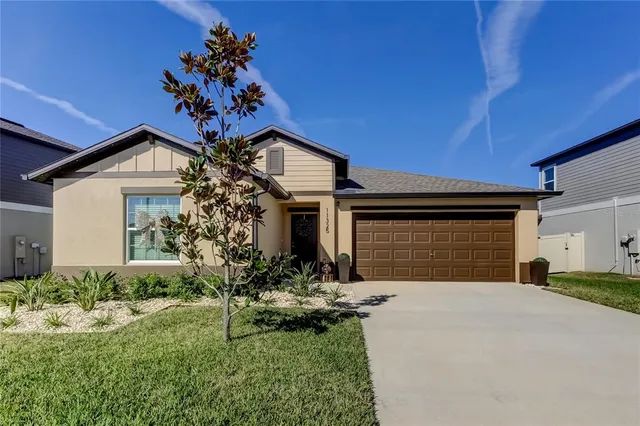 a front view of a house with a yard and garage