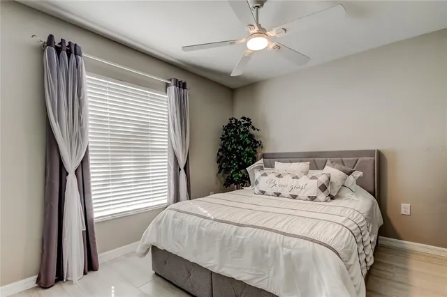 a bedroom with a large bed and a chandelier