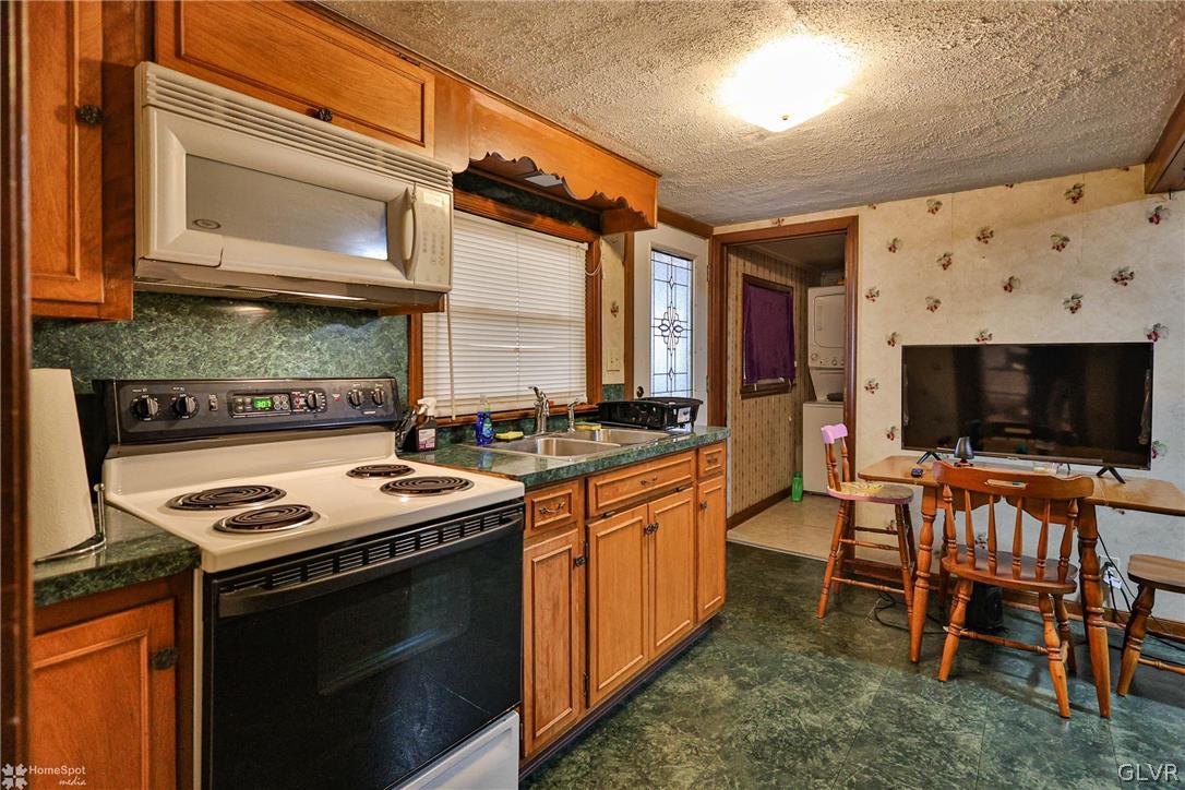 292 East Moorestown Road Wind Gap, PA 18091 - Photo 13 of 46 a kitchen with stainless steel appliances a stove a sink and a microwave