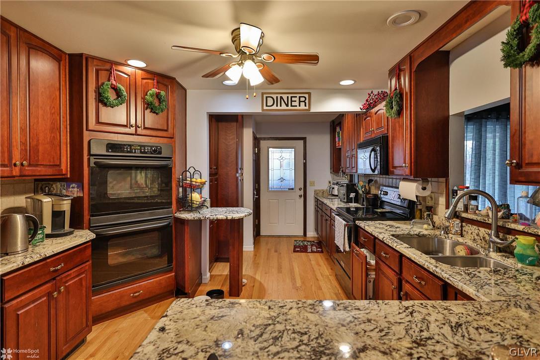 292 East Moorestown Road Wind Gap, PA 18091 - Photo 19 of 46 a kitchen with stainless steel appliances granite countertop a stove refrigerator and cabinets