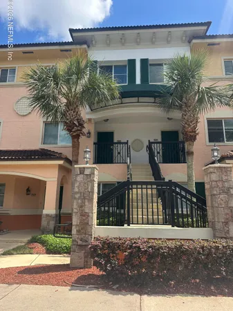 a front view of a house with plants