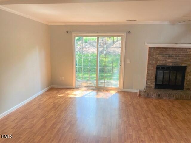 4507 Still Pines Drive Raleigh, NC 27613 - Photo 12 of 27 a view of empty room with wooden floor and fireplace