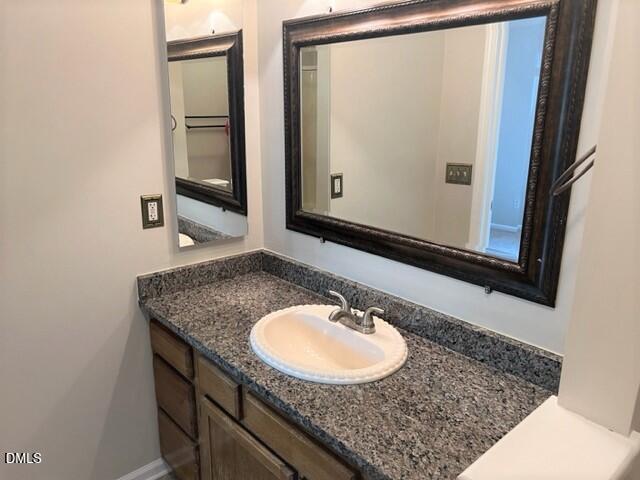 4507 Still Pines Drive Raleigh, NC 27613 - Photo 20 of 27 a bathroom with a granite countertop sink and a mirror