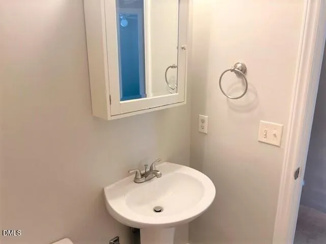 a bathroom with a sink and mirror