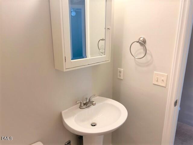 4507 Still Pines Drive Raleigh, NC 27613 - Photo 25 of 27 a bathroom with a sink and mirror
