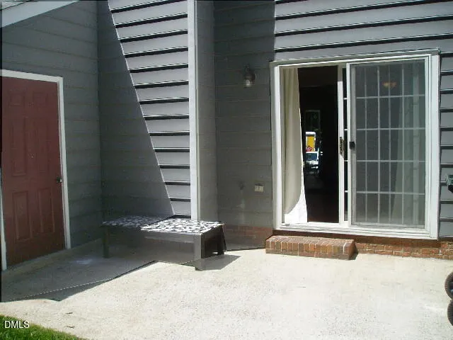 a view of a bedroom with a chair and floor to ceiling window