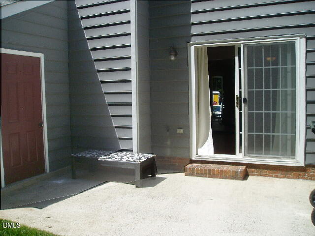 4507 Still Pines Drive Raleigh, NC 27613 - Photo 26 of 27 a view of a bedroom with a chair and floor to ceiling window