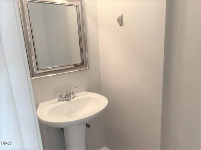 a bathroom with a sink and mirror
