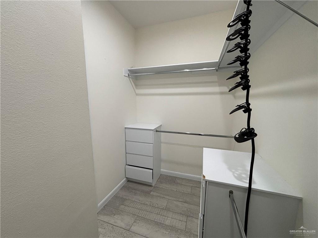 212 Lauryn Drive, Unit 3 San Juan, TX 78589 - Photo 14 of 27 a view of a room with racks on the wall