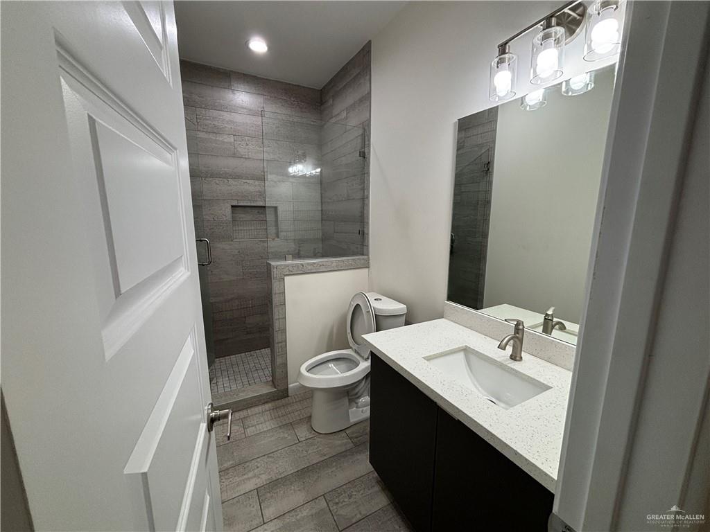 212 Lauryn Drive, Unit 3 San Juan, TX 78589 - Photo 18 of 27 a bathroom with a sink toilet and a mirror