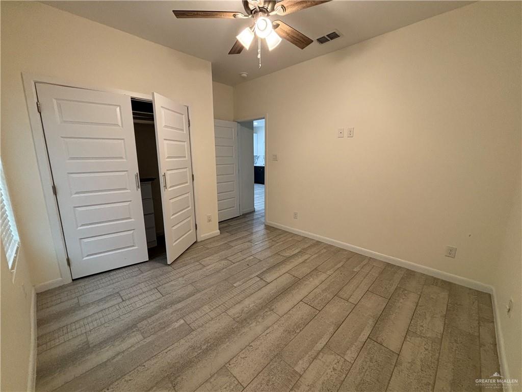 212 Lauryn Drive, Unit 3 San Juan, TX 78589 - Photo 22 of 27 wooden floor in an empty room with a window