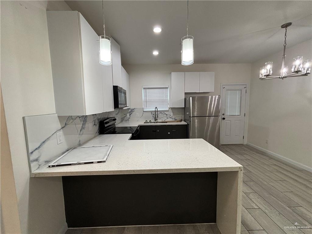 212 Lauryn Drive, Unit 3 San Juan, TX 78589 - Photo 4 of 27 a kitchen with a sink a refrigerator and a stove