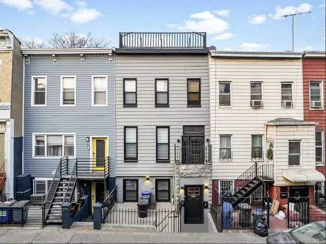 a group of people sitting in front of a building