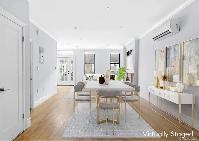a view of a a dining room with furniture window and wooden floor