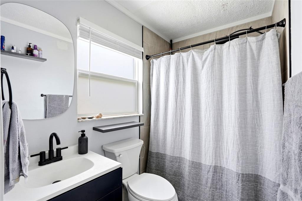 2311 Bay Boulevard Indian Rocks Beach, FL 33785 - Photo 62 of 80 a bathroom with a sink mirror and toilet