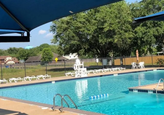 a view of a lake with a house swimming pool and outdoor space