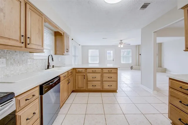 a kitchen with a sink a stove and cabinets