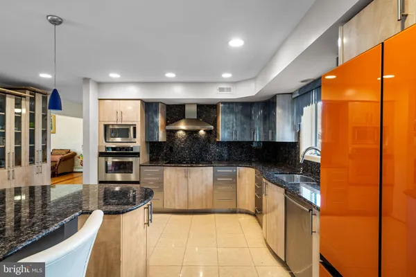 a kitchen with stainless steel appliances a stove a microwave and a sink