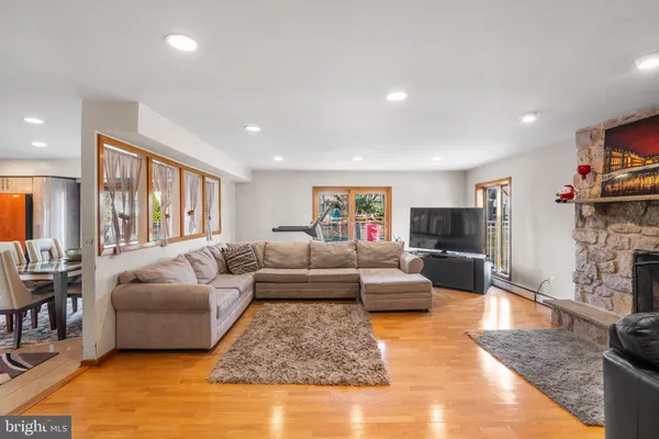 a living room with furniture and a kitchen