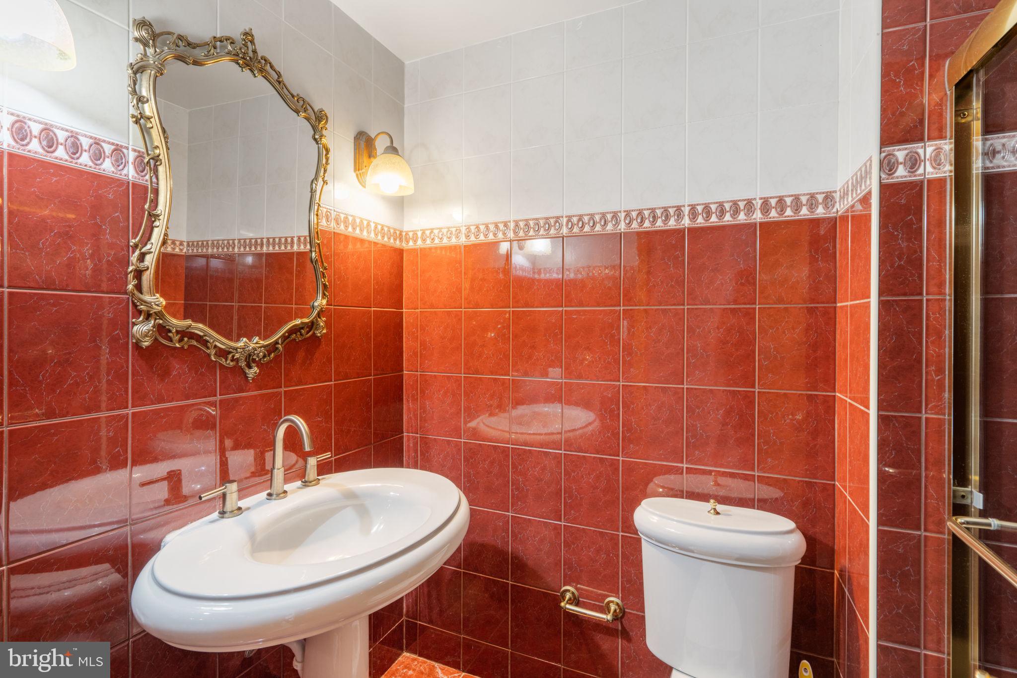 509 Long Lane Huntingdon Valley, PA 19006 - Photo 23 of 46 a bathroom with a sink toilet and a mirror