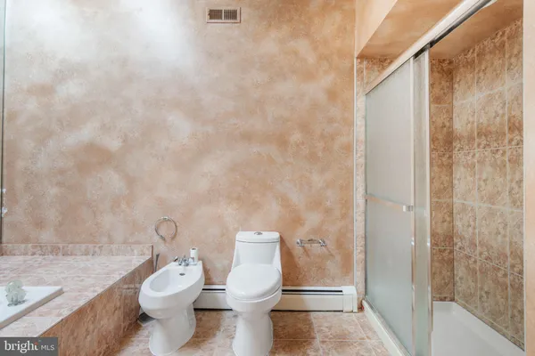 a bathroom with a sink a bathtub and a shower