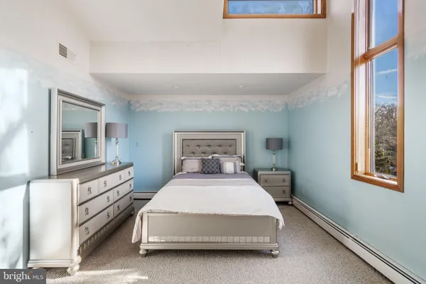 a bedroom with furniture and a window