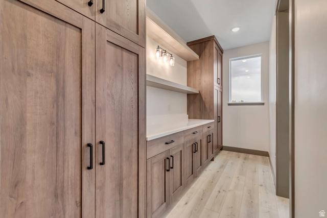 3317 South 1000 West, Unit 6010 Logan, UT 84321 - Photo 19 of 34 Bar area featuring wood finish cabinets, light wood finished floors, open shelves, and recessed lighting