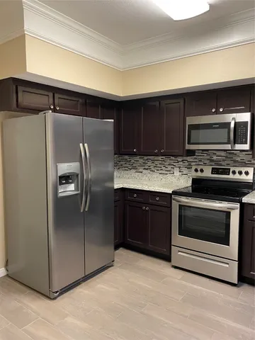 an empty room with closet and a chandelier fan