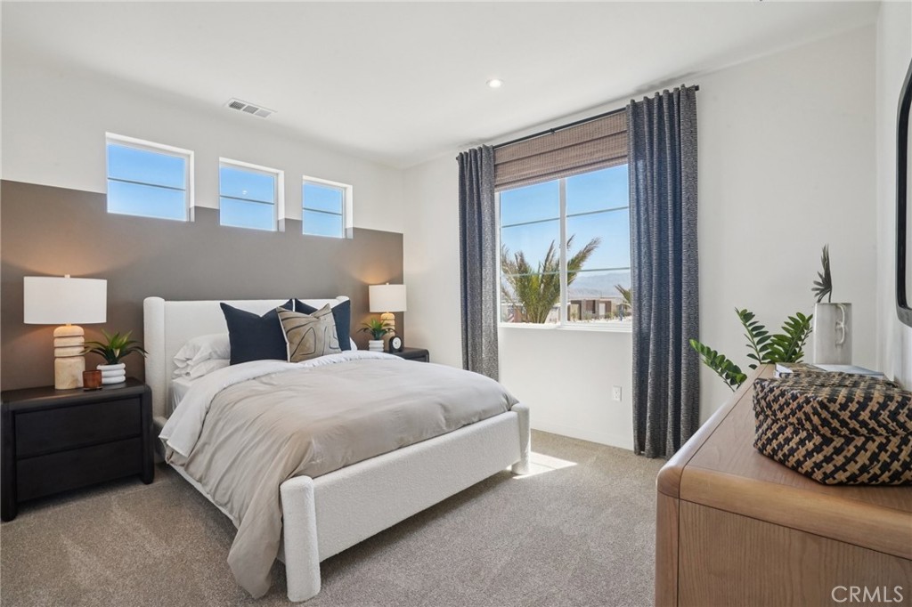 73525 Raphael Drive Palm Desert, CA 92211 - Photo 24 of 41 a bedroom with a bed and a couch