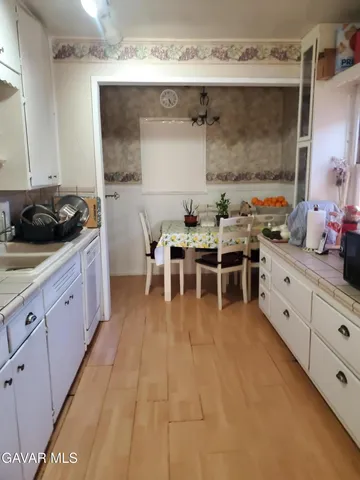 a kitchen with stainless steel appliances a sink and cabinets