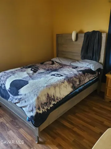 a bed sitting in a bedroom next to a cabinet