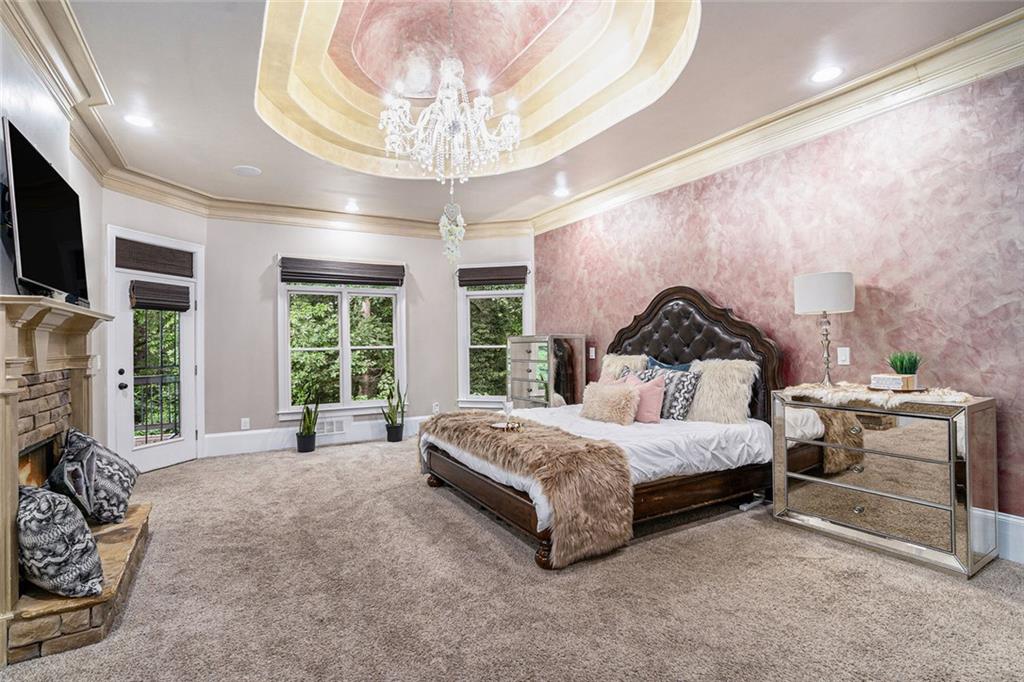 4025 Cascade Road Atlanta, GA 30331 - Photo 21 of 48 a spacious bedroom with a bed and a chandelier