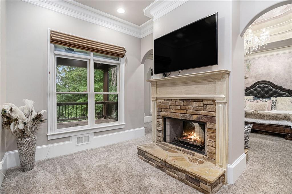 4025 Cascade Road Atlanta, GA 30331 - Photo 23 of 48 a living room with furniture a flat screen tv and a fireplace