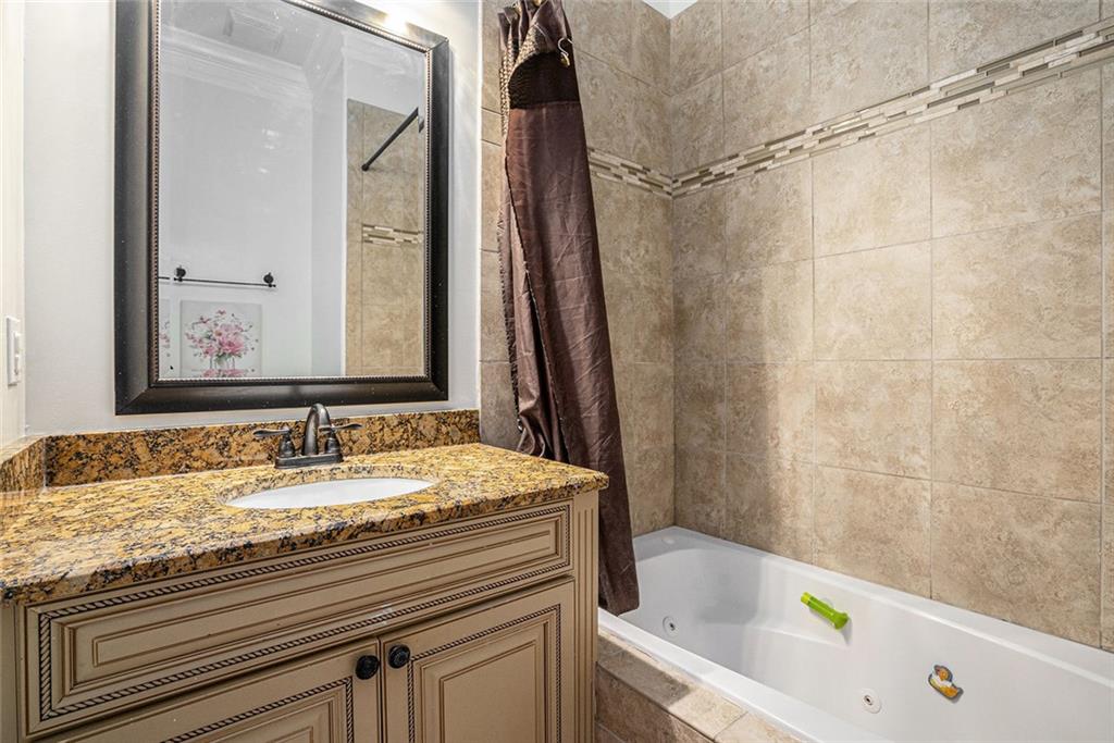 4025 Cascade Road Atlanta, GA 30331 - Photo 27 of 48 a bathroom with a granite countertop sink and a mirror
