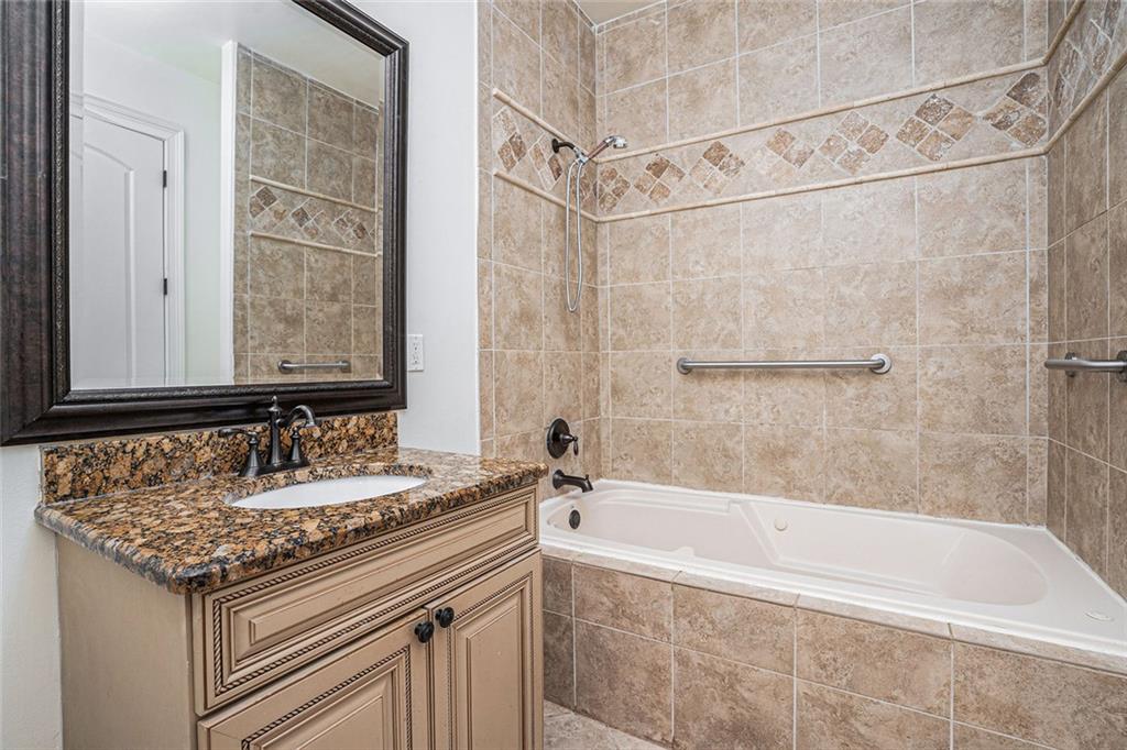 4025 Cascade Road Atlanta, GA 30331 - Photo 35 of 48 a bathroom with a granite countertop sink a mirror and a bathtub