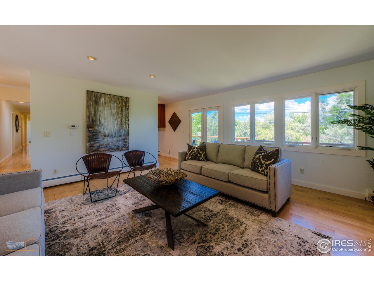 6423 Clearview Road Boulder, CO 80303 - Photo 4 of 40 a living room with furniture a large window and wooden floor
