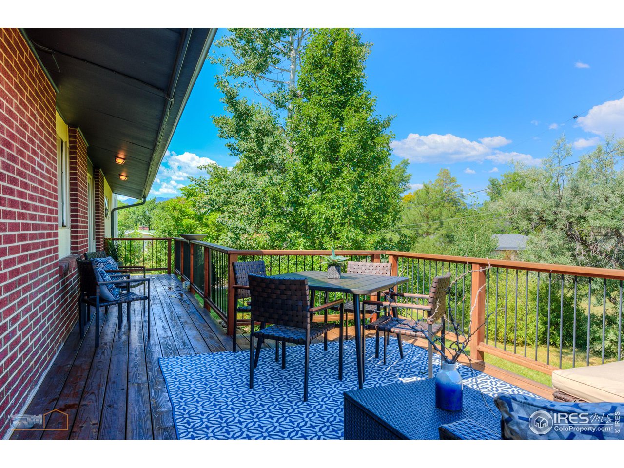 6423 Clearview Road Boulder, CO 80303 - Photo 10 of 40 a balcony with wooden floor table and chairs