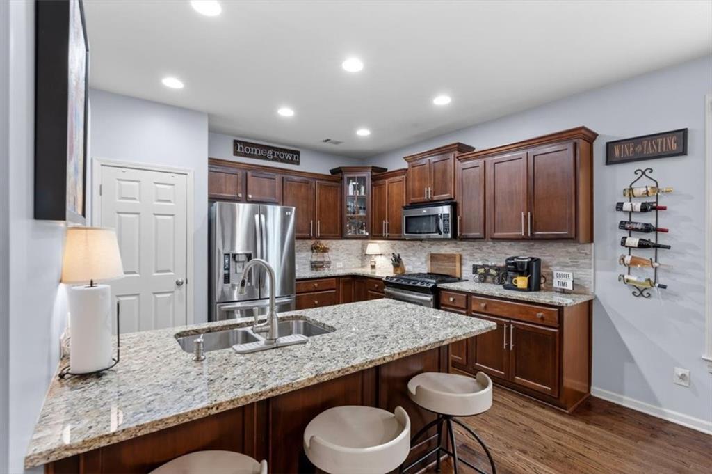 201 Providence Lane Canton, GA 30114 - Photo 12 of 50 a kitchen with granite countertop kitchen island stainless steel appliances a sink and a refrigerator