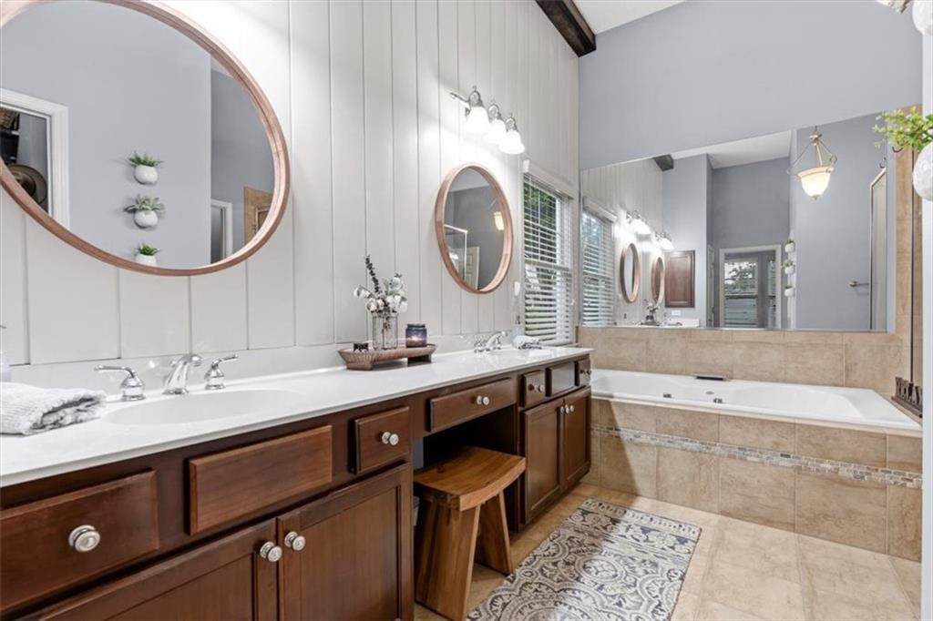 201 Providence Lane Canton, GA 30114 - Photo 23 of 50 a spacious bathroom with a double vanity sink and a mirror